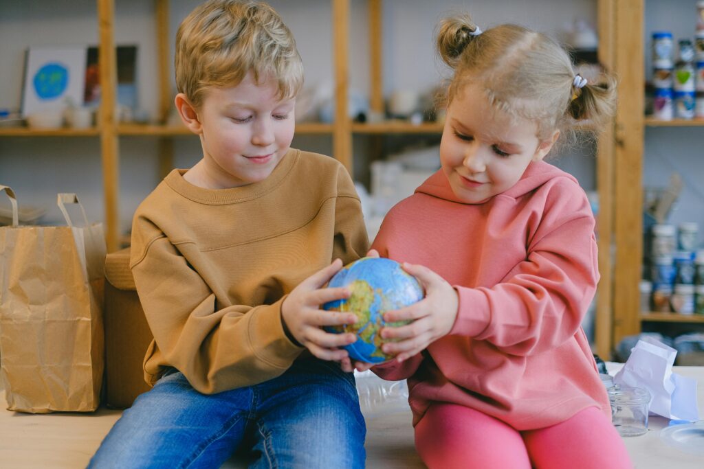 Two Children Holding a Globe